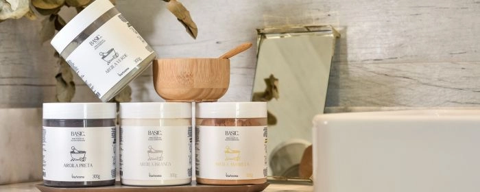 Quatro potes de argila para rosto e cabelos da Via Aroma e um bowl e uma colher de madeira